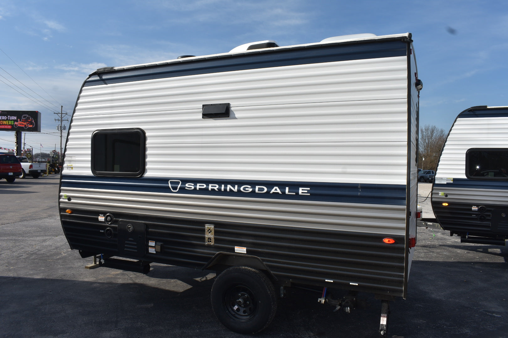 Springdale travel trailer parked in a lot with clear sky