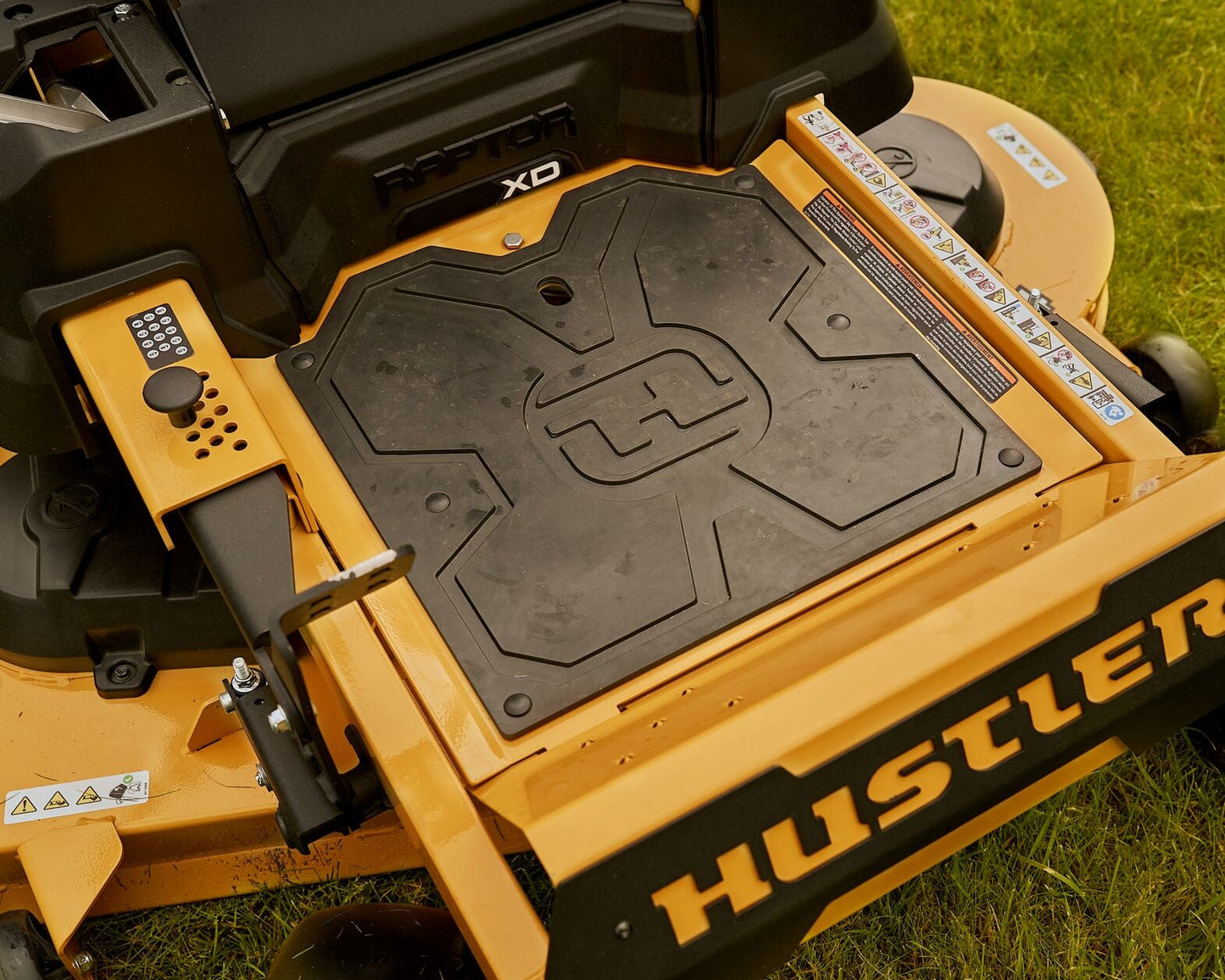 Close-up of a Hustler lawn mower on grass