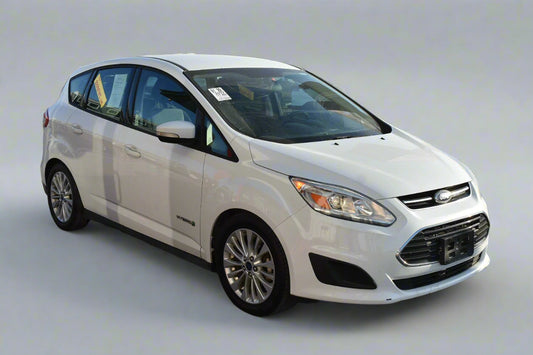 White Ford car parked on a street with ABC Motors logo in the corner.